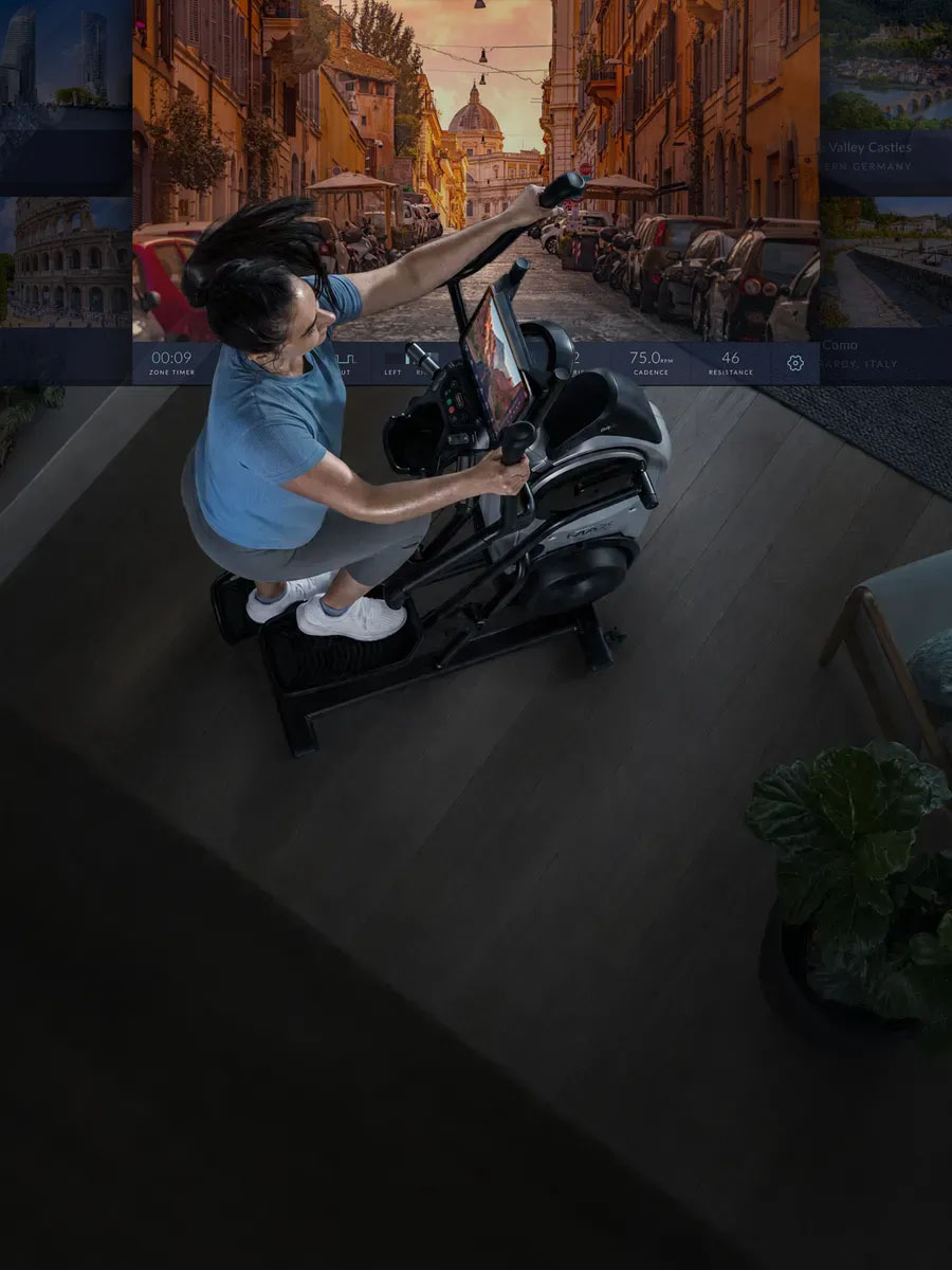 使用者在家踩 BowFlex M6，並以自己的平板觀看全球實景路線